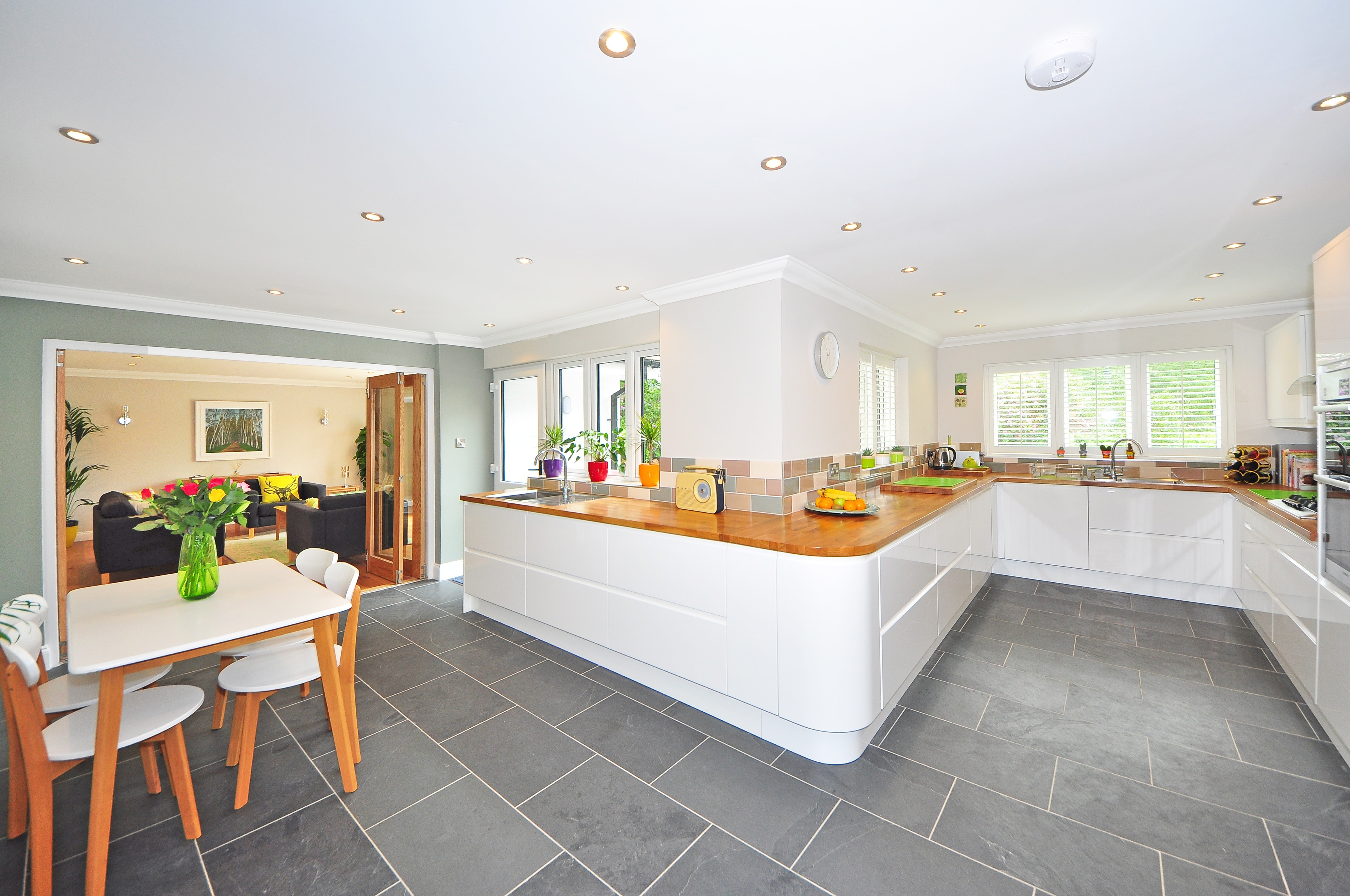 clean kitchen with grey tile floor and kitchen table