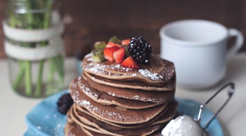 Chocolate pancakes with strawberries and blackberries on the top