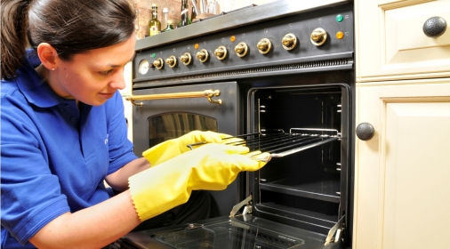 Ovenclean specialist putting an oven rack into oven