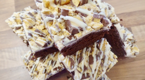 Slices of cake with icing and crunchie pieces on the top