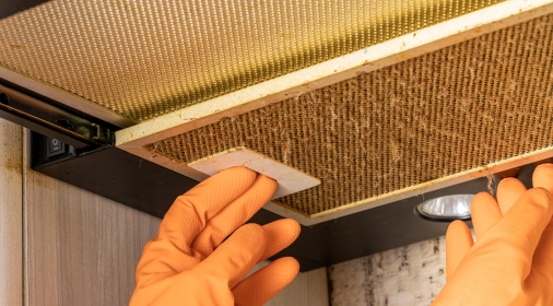 cleaning and washing dirty cooker hood filter. fat and dust at filter. domestic kitchen.