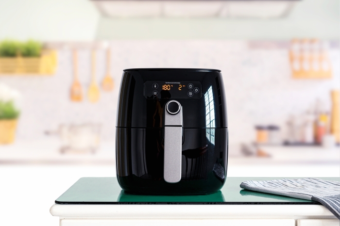 Air fryer machine cooking potato fried in kitchen. Lifestyle of new normal cooking.