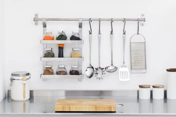 Kitchen utensils and spices in bowls in stainless steel kitchenKitchen utensils and spices in bowls in stainless steel kitchen