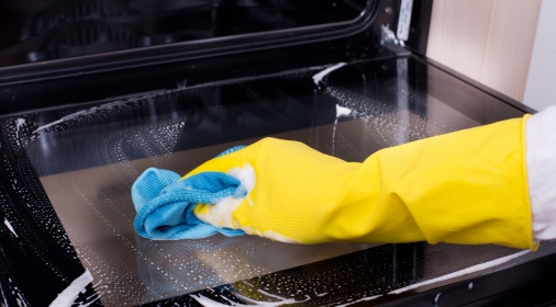 Someone cleaning oven door