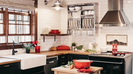 kitchen with black cupboards and red pots