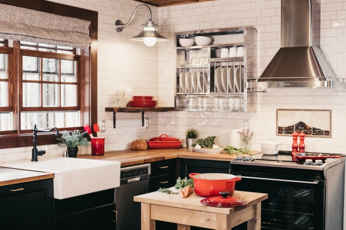 kitchen with black cupboards and red pots