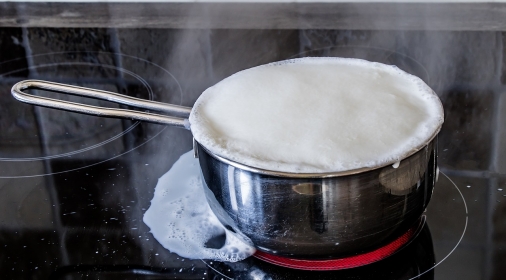 Pan boiling over the top creating stains