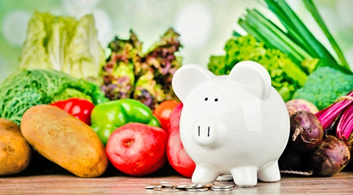 white pig money box with vegetables in the background