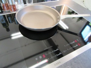 Shiny ceramic hob with frying pan on the top