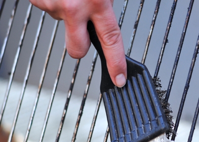 Someone cleaning an oven rack