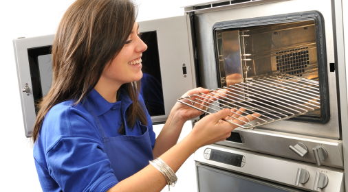 Ovenclean specialist putting oven rack in an oven