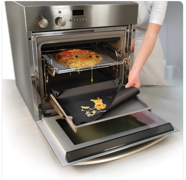 pizza in oven dripping onto oven liner at bottom of oven